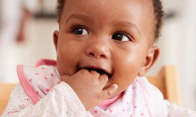 Baby with hand in her mouth,